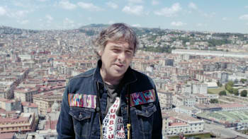 Hubertus von Hohenlohe standing in front of a vista of Naples.