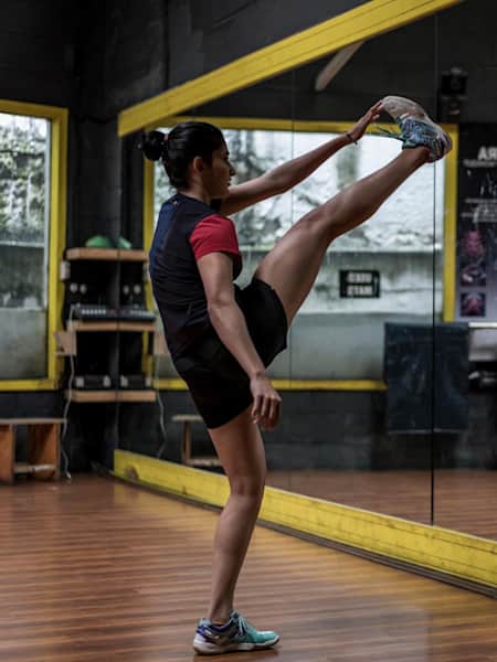 Ashwini Ponnappa stretches before training