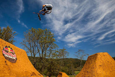 Polish rider Dawid Godziek pulls a toboggan over a jump set during practice at Red bull Dreamline in Asheville, North Carolina