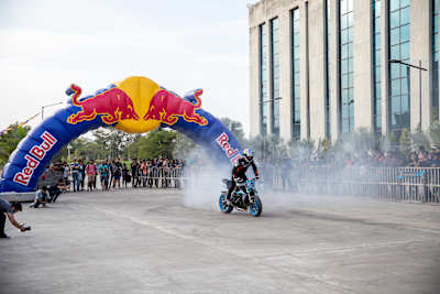 Aaron Colton performs a rolling burnout on his motorcycle during a showcase.