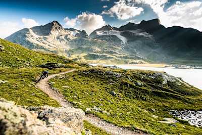 St Moritz trail basked in sun with lake and mountain back drop.