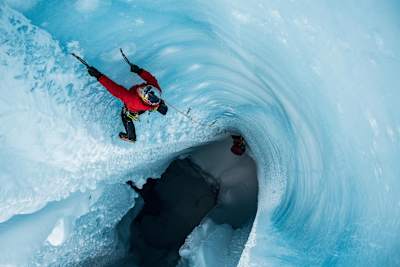 Will Gladd ice climbs out of a moulin during his trip to explore the Greenland ice cap in 2018.