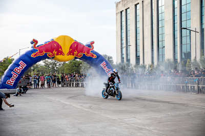 Aaron Colton performs a rolling burnout on his motorcycle during a showcase.