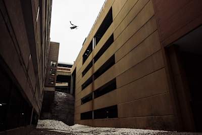 Levi LaVallee doing a six-storey alley gap on a snowmobile in St Paul, Minnesota, USA.