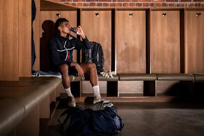 Indian football goalkeeper Gurpreet Singh Sandhu drinks Red Bull in a changing room before a match.