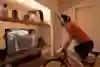 Rider on turbo trainer watching Zwift.