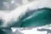 Surfer Tamayo Perry rides the tube at Pipeline in Hawaii.