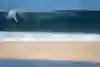 Surfer Cam Richards takes off on a huge wave at Pipeline in Hawaii.