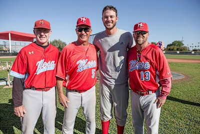 Kris Bryant poses with coaches after pranking a local baseball team