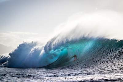 Surfer Mark Healey pictured riding a wave at Pipeline in a photo by Christa Funk.