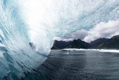 A huge wave crashes over the ocean during the shooting of Big-Wave Surfing.