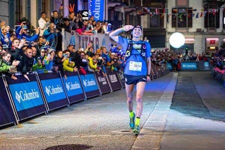 Ultra Runner Tom Evans crossing the line at the Courmayeur Champex Chamonix (CCC) race at Ultra-Trail de Mont Blanc (UTMB) in 2018.
