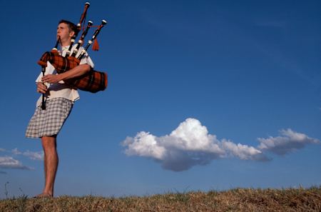 man playing the a bagpipe