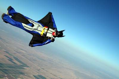 A wingsuit in a Batman outfit goes skydiving