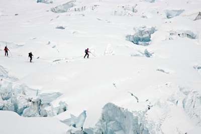Axel Naglich and Peter Ressmann hiking over a glacier.