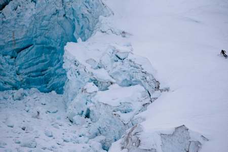 Sheldon Kerr skis past a glacier above the Barnard Glacier, Wrangell St Elias Mountains, Alaska.