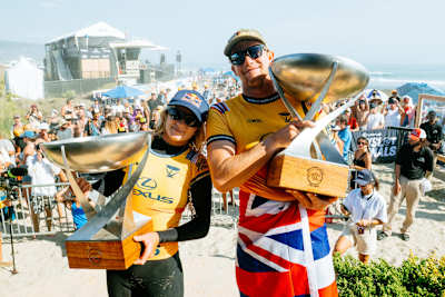 Caity Simmers and John John Florence on stage after winning the WSL Finals at Lower Trestles, California