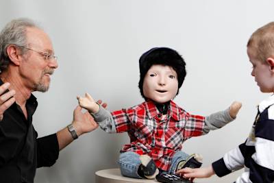 Dr. Ben Robins, leader of the Kaspar Project and Kaspar, the robot designed to help autistic children develop social skills more easily.
