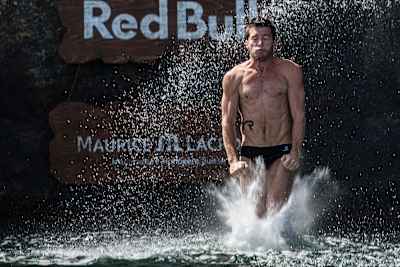 Steven LoBue flexes his muscles as he enters the water in Red Bull Cliff Diving.