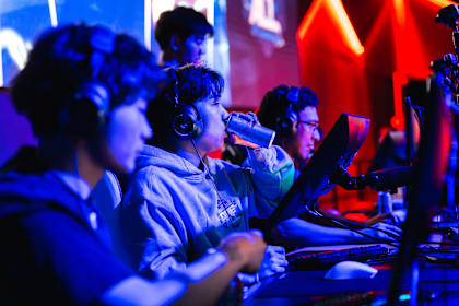 Team SchrodingerLee player energises with a Red Bull during the Red Bull One For All esports event at Fortress Melbourne, Australia, on June 7, 2025, under vibrant gaming lights