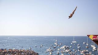 Alessandro De Rose dives from the 27m platform during the first competition day of the third stop of the Red Bull Cliff Diving World Series at Polignano a Mare, Italy on 23 July 2017.