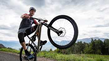 Mountain biker Tom Oehler performs a wheelie