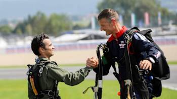 Dani Pedrosa junto a un miembro del Red Bull Skydive team después de saltar sobre el circuito del Red Bull Ring en los días previos al Gran Premio de Austria.