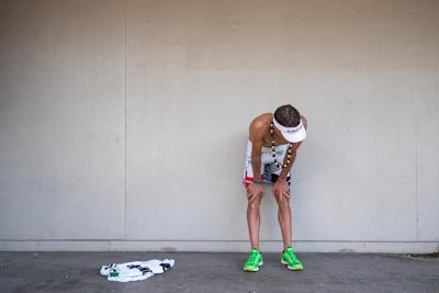 Braden Currie bends over in exhaustion after the IRONMAN World Championship.