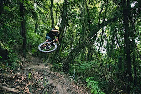 Cole Lucas styles a jump while riding New Zealand’s Kataore bike trail.
