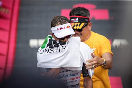 Braden Currie gets a towel to wipe himself down after finishing the 2018 Ironman World Championships.
