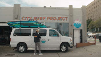 A van is parked outside the offices of The City Surf Project in San Francisco, California, USA.
