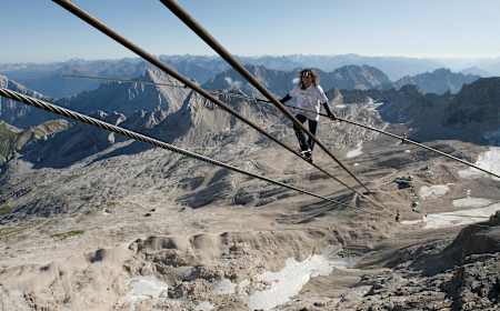 Freddy Nock balancing on the cable car ropeway at the Zugspitze in Switzerland.