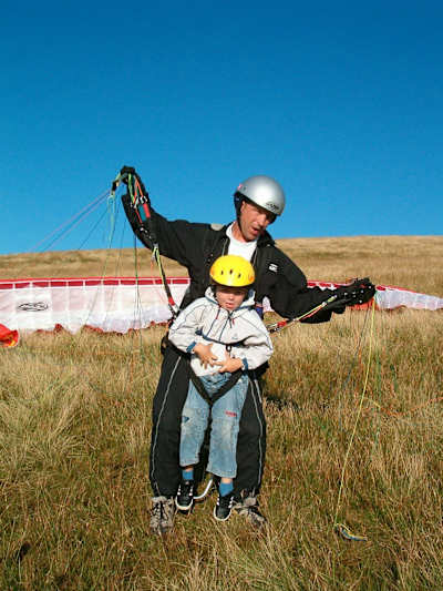 Photo of Jack Pimblett paragliding with his father as a child.