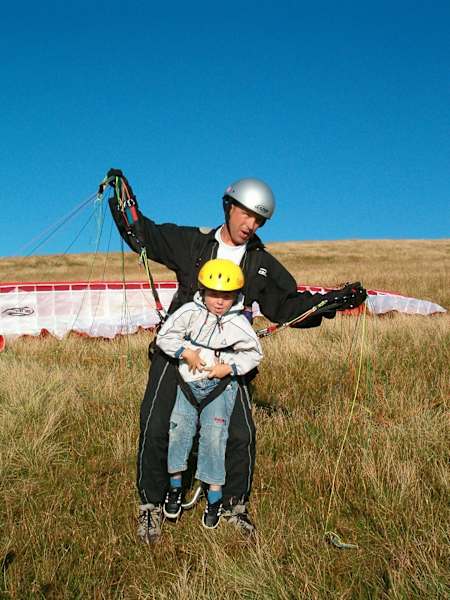 Photo of Jack Pimblett paragliding with his father as a child.