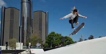 Skateboarder doing a kickflip at a skate park