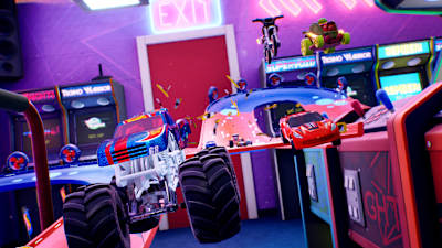 Screenshot aus Hot Wheels Unleashed 2 zeigt viele Fahrzeuge beim Sprung in einer Spielhalle mit einem Monstertruck im Vordergrund.