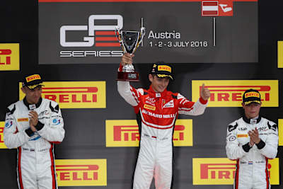 A photo of Charles Leclerc (centre) on the podium after winning the GP3 race at Red Bull Ring.