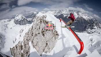 Wakeboard pro and snowboard ace Felix Georgii performs a boardslide over the gap rail at Slopestyle on the edge.