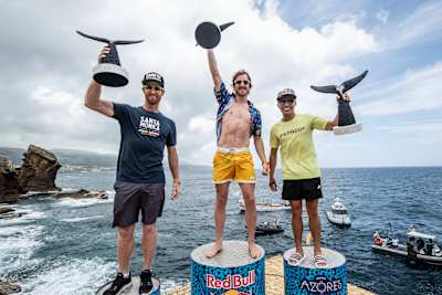 Andy Jones (L) of the USA, Gary Hunt (C) of the UK and Jonathan Paredes of Mexico celebrate at the fourth stop of the Red Bull Cliff Diving World Series in Azores, Portugal on June 22, 2019.