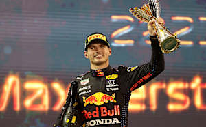 Max Verstappen of Netherlands and Red Bull Racing celebrates on the podium during the F1 Grand Prix of Abu Dhabi at Yas Marina Circuit on December 12, 2021 in Abu Dhabi, United Arab Emirates.