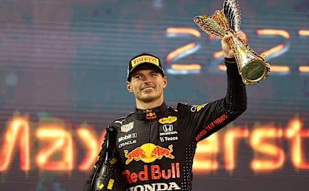 Max Verstappen of Netherlands and Red Bull Racing celebrates on the podium during the F1 Grand Prix of Abu Dhabi at Yas Marina Circuit on December 12, 2021 in Abu Dhabi, United Arab Emirates.