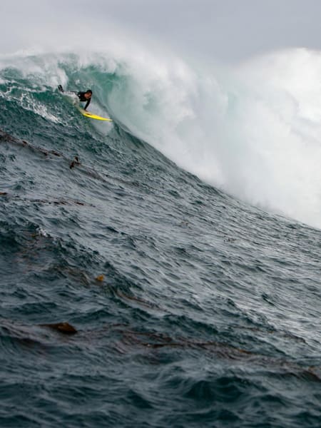Professional surfer Anthony "Tazzy" Tashnik (left) attempts to paddle into a wave a Central California's Ghost Tree.