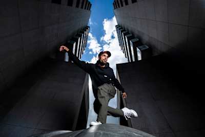 Majid posing between two buildings.