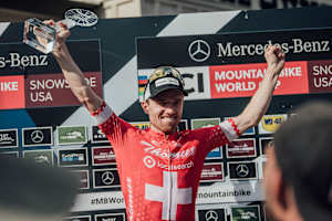 Mathias Fluckinger seen receiving in the men's XCO over World Cup trophy at the 2021 Snowshoe race.