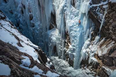 Dawn Glanc ice climbing in Colorado, USA in a photograph shot by renowned adventure photographer Michael Clark.