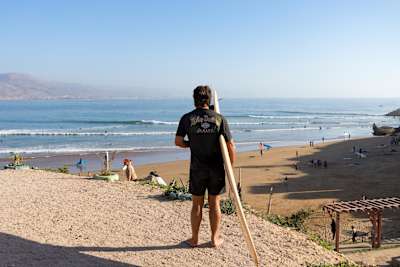 No Contest host Ashton Goggans readies himself to surf in Morocco