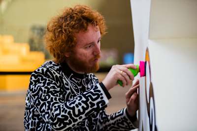 British artist and Red Bull Doodle Art World Final judge Sam Cox, aka Mr Doodle, creates an inspirational work at Amsterdam's STRAAT Museum in April 2023. 