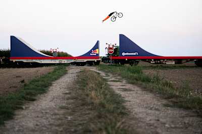 Dawid Godziek fait un superman en vélo entre les wagons d'un train pendant le tournage de Red Bull Bike Express.