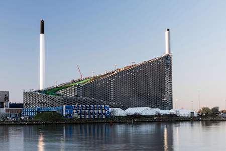 The CopenHill building as seen from a water tributary in Copenhagen.