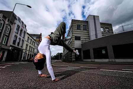 Logistx stands on her hands with an arched back, performing a hollowback freeze during The Notorious IBE festival in Heerlen, The Netherlands, on August 11, 2019.
